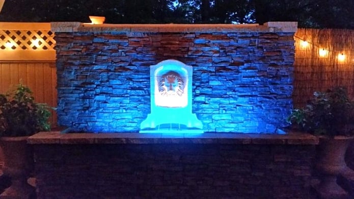 Water wall with blue LED lights, the cables and wires hidden behind the faux panels attached to the surface.
