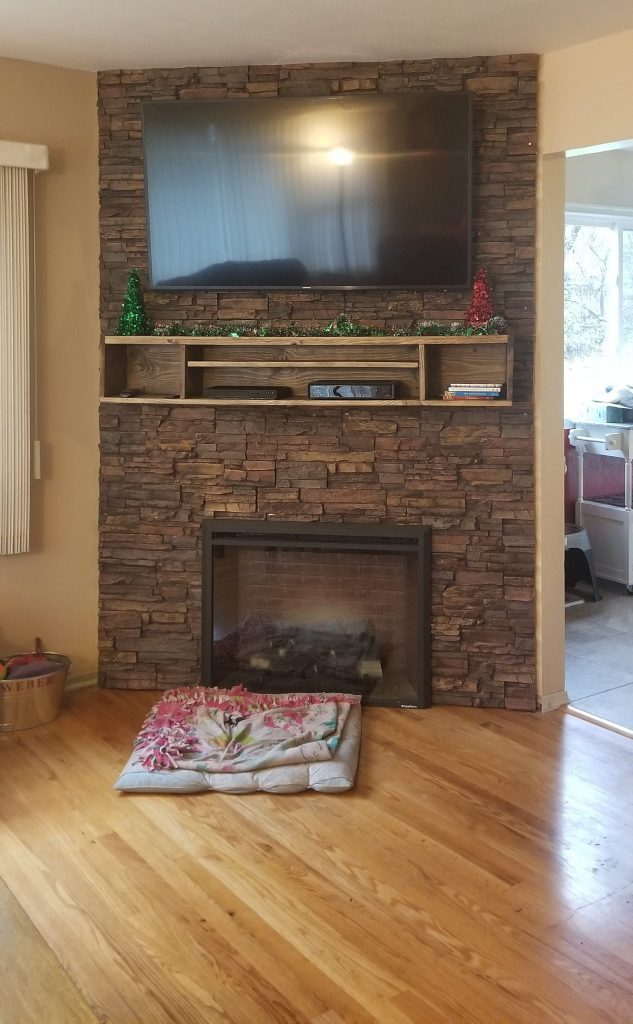 Fireplace and TV wall covered with Norwich Stacked Stone panels.