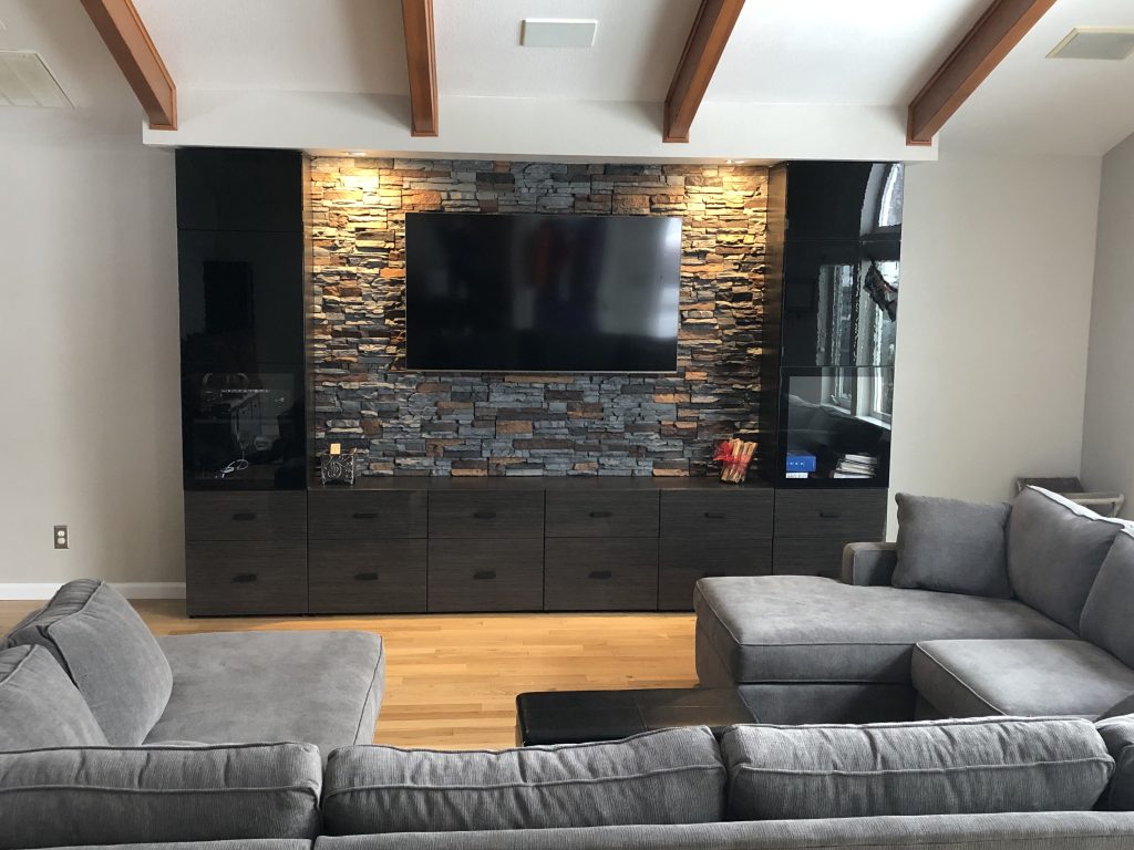 Home media center featuring a stone style feature wall.