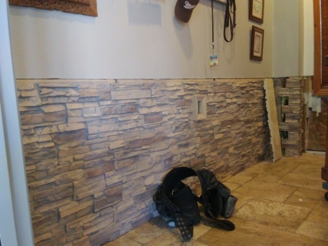 Replacing flood-damaged drywall with waterproof panels.