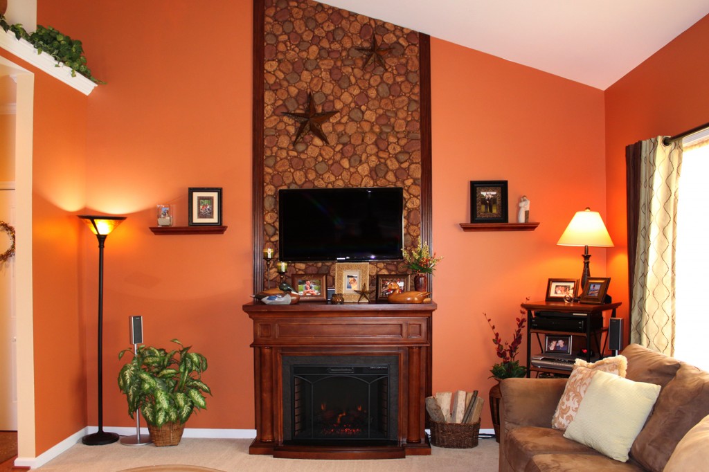 Electric fireplace backed by a riverstone style wall