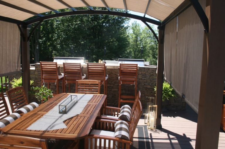 Elevated deck with grill island covered with Norwich Stacked Stone panels in Taffy Beige.