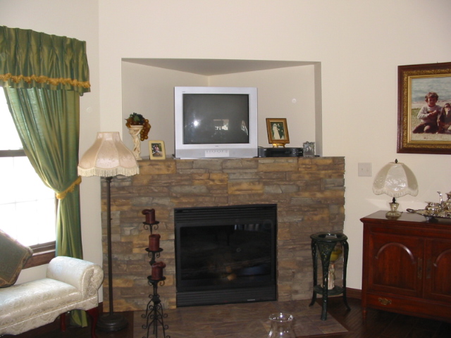 Fireplace makeover on a budget with a new faux stacked stone surround.