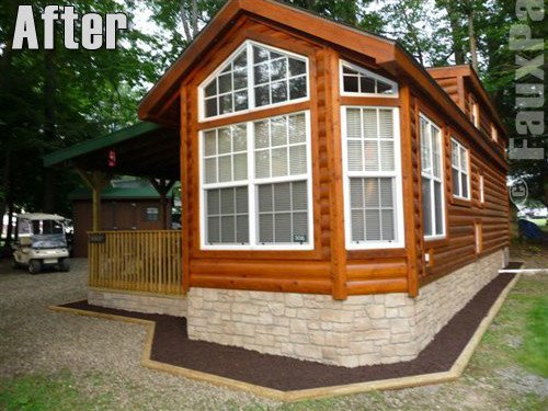 Mobile home after stone style skirting is installed.